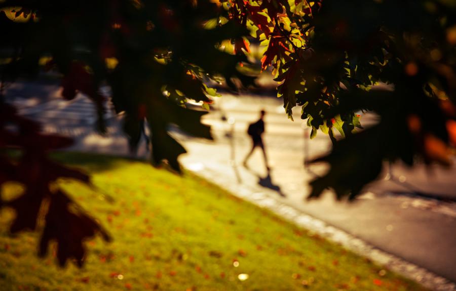 Student walking past Rockefeller Hall